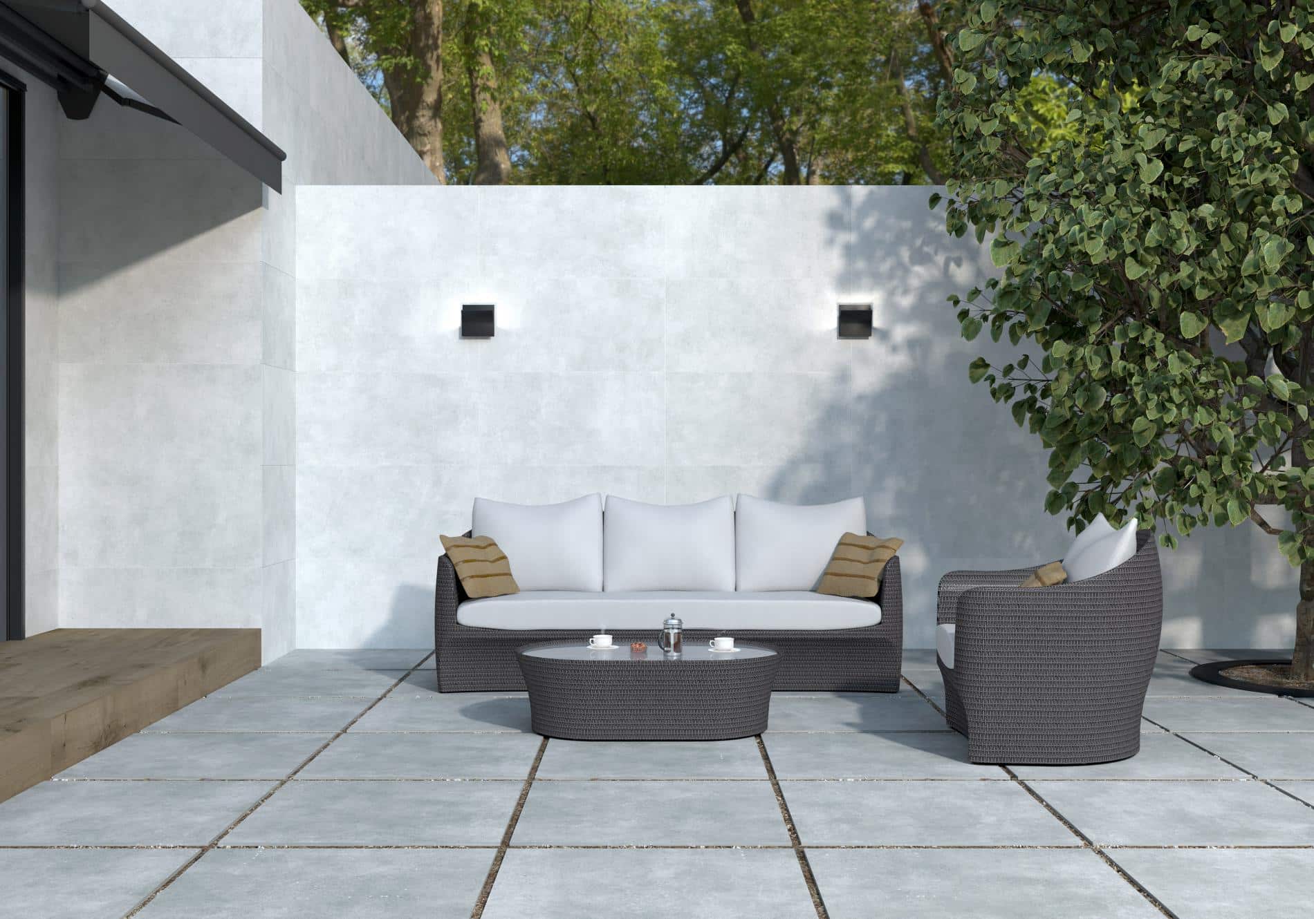 White concrete used at an outdoor seating area with a small table and outside sofa