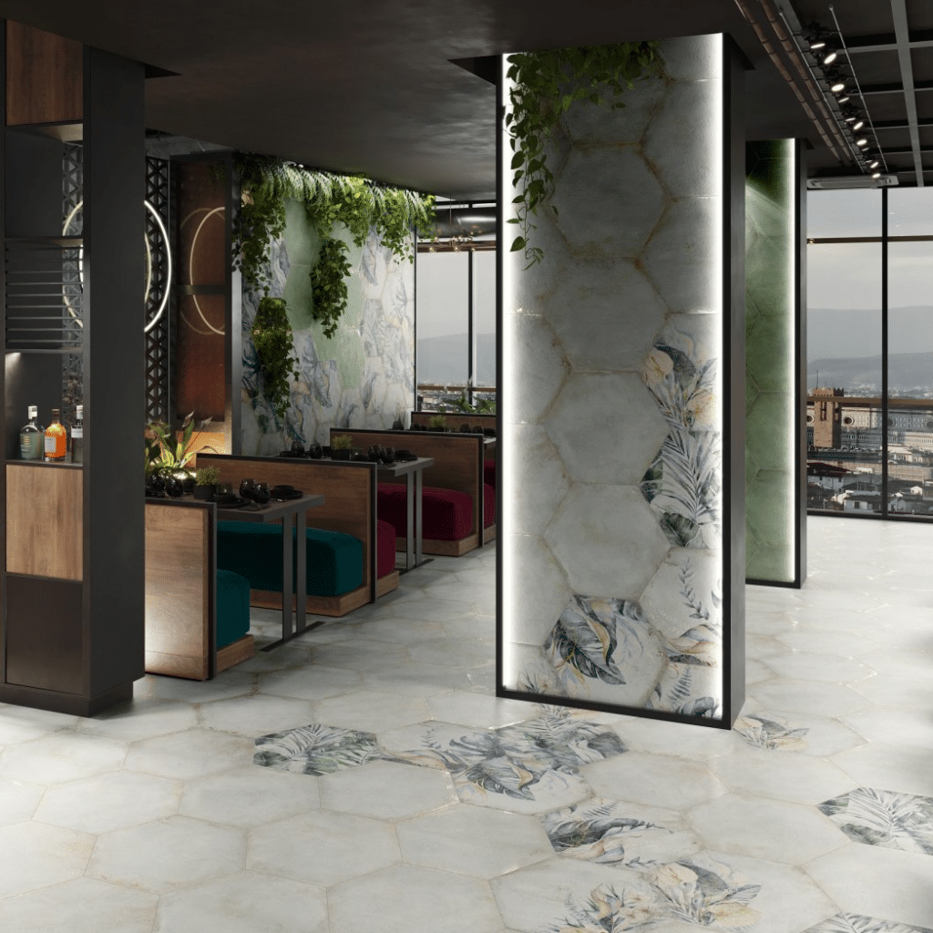 Modern room with hexagonal tiles, large windows, green plants, and decorated columns.