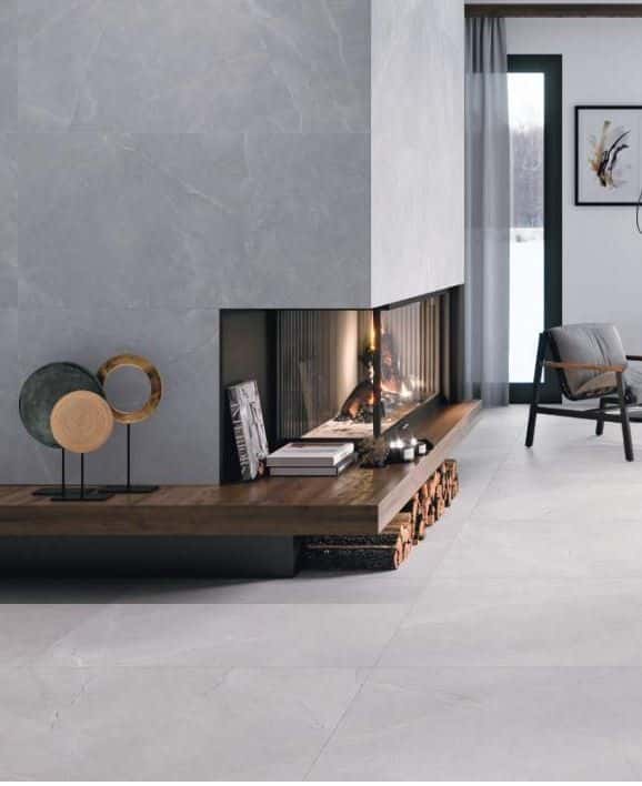 Modern living room with a fireplace, chair, and wood decor.