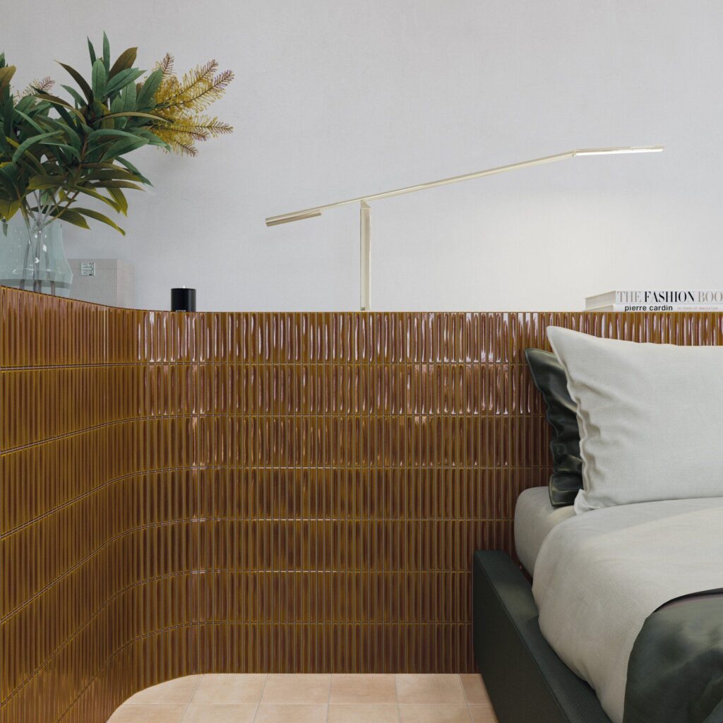 Modern bedroom corner with a brown tiled wall, green bedding, and a minimalist lamp.