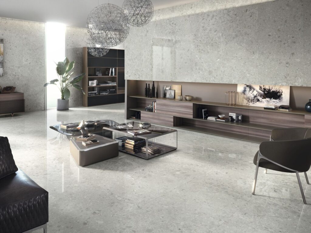 Modern living room with light stone floors, a low coffee table, and minimalist furniture.