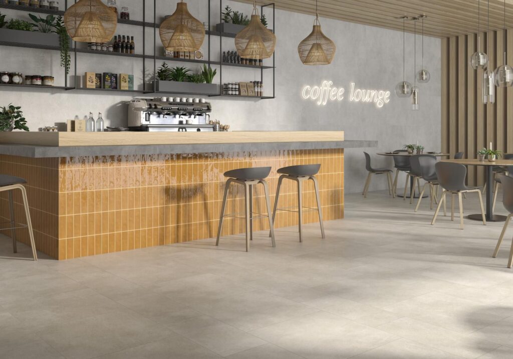 pam1900x2126-1e9eef97-1920w.jpg Modern coffee lounge with a tiled counter, bar stools, and cozy seating area.