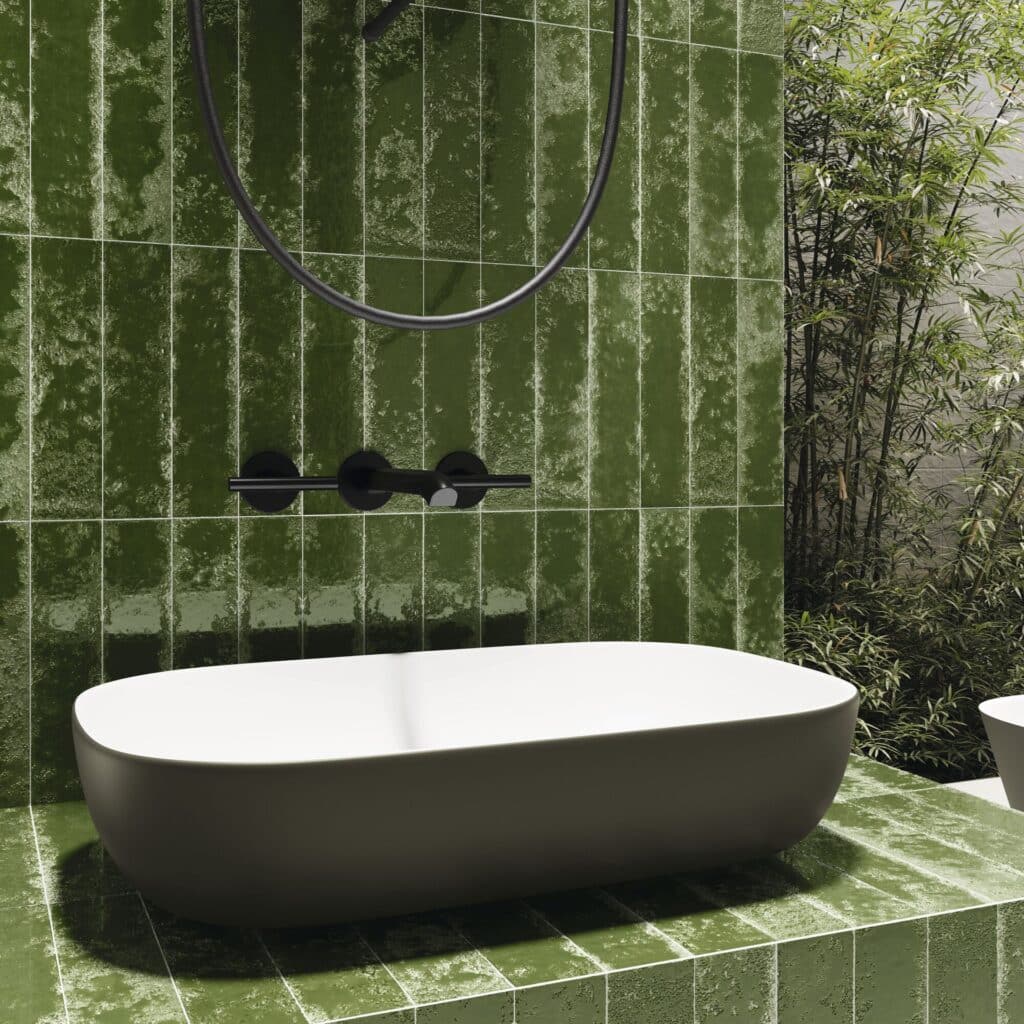 1-d326e84f-1920w.jpg Modern bathroom sink on green tiled countertop, with a round mirror and outdoor greenery visible.