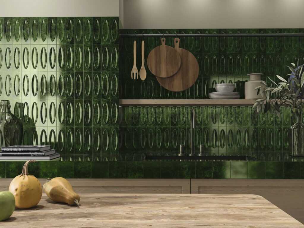 7-52b29921-1920w.jpg Modern kitchen with green oval patterned tiles, wooden utensils, and fruit on the counter.