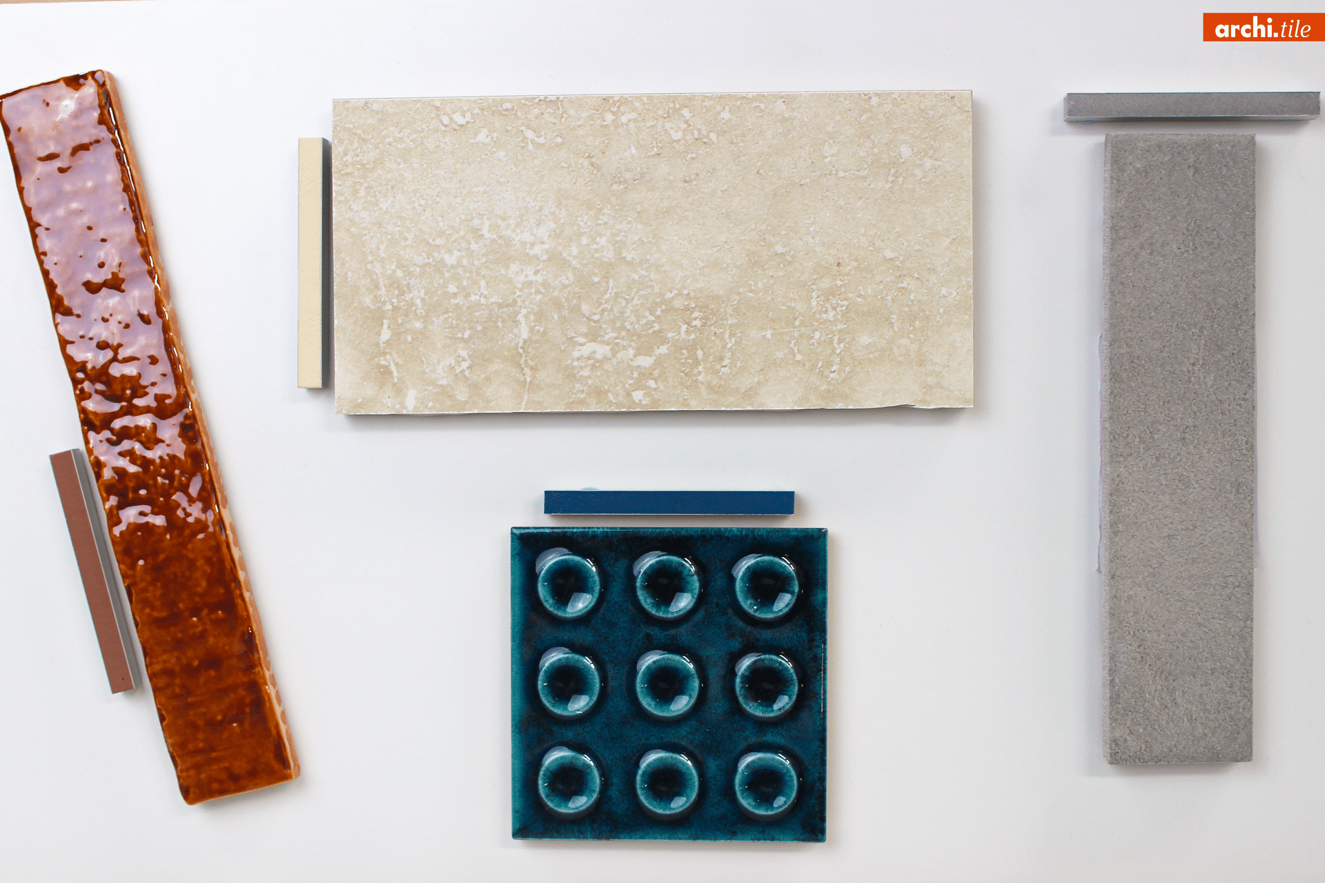 Four textured tiles of different shapes and colors displayed on a white background.