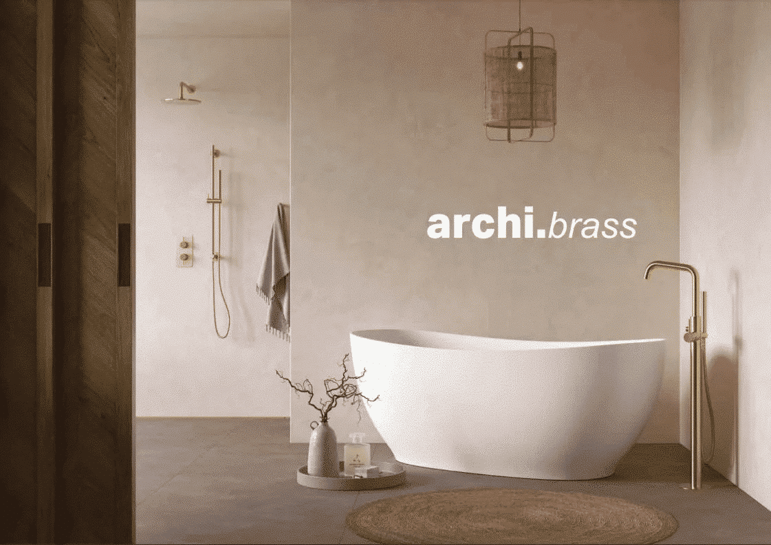 Modern bathroom with a freestanding tub and brass fixtures; "archi.brass" text on wall.
