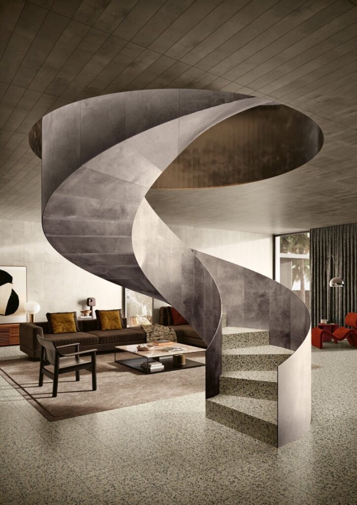 Modern concrete spiral staircase in a stylish living room with neutral colors and contemporary decor.