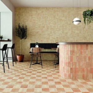 Modern cafe with checkered tile floor, wood furniture, potted plant, and hanging light fixture.