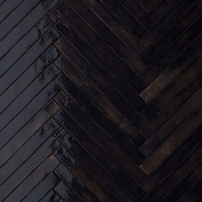 Dark wooden planks arranged in a herringbone pattern.