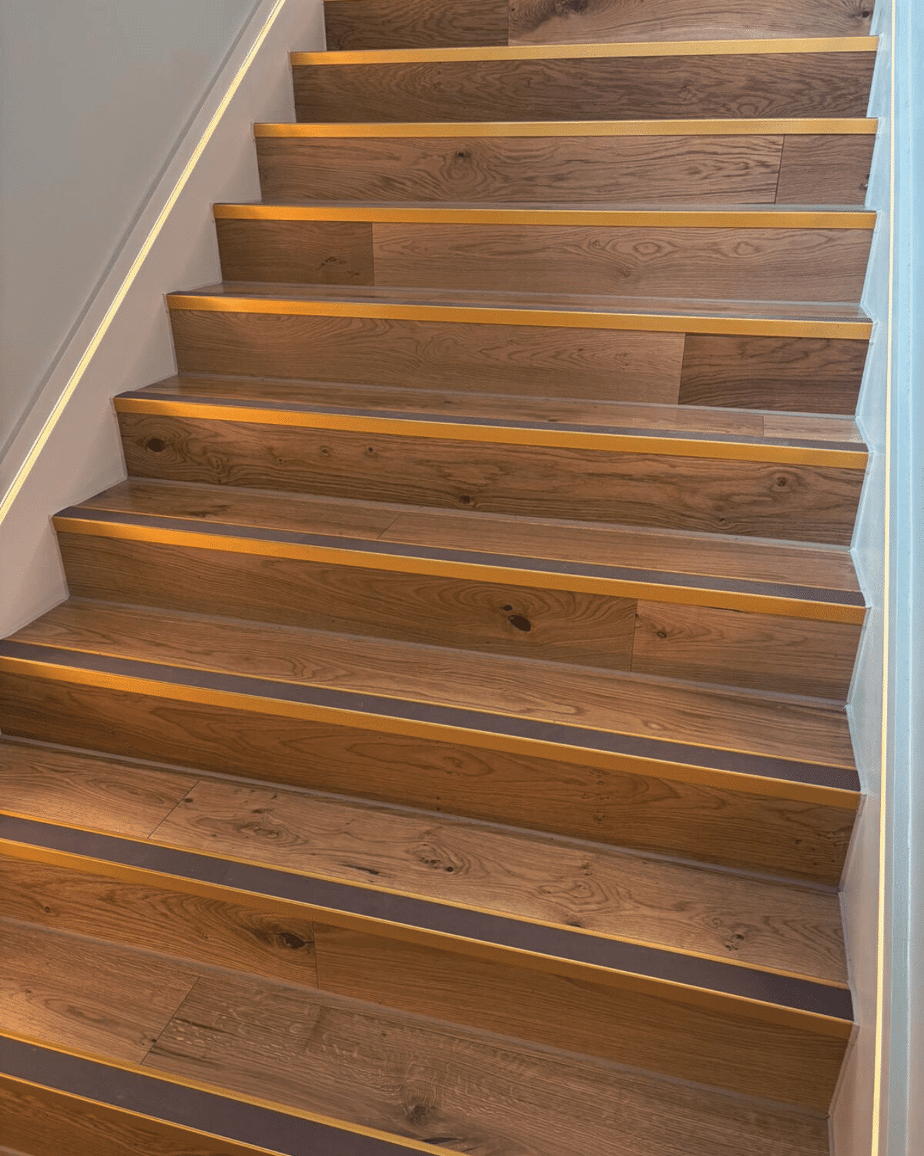 Wooden stairs with built-in LED lighting along each step.